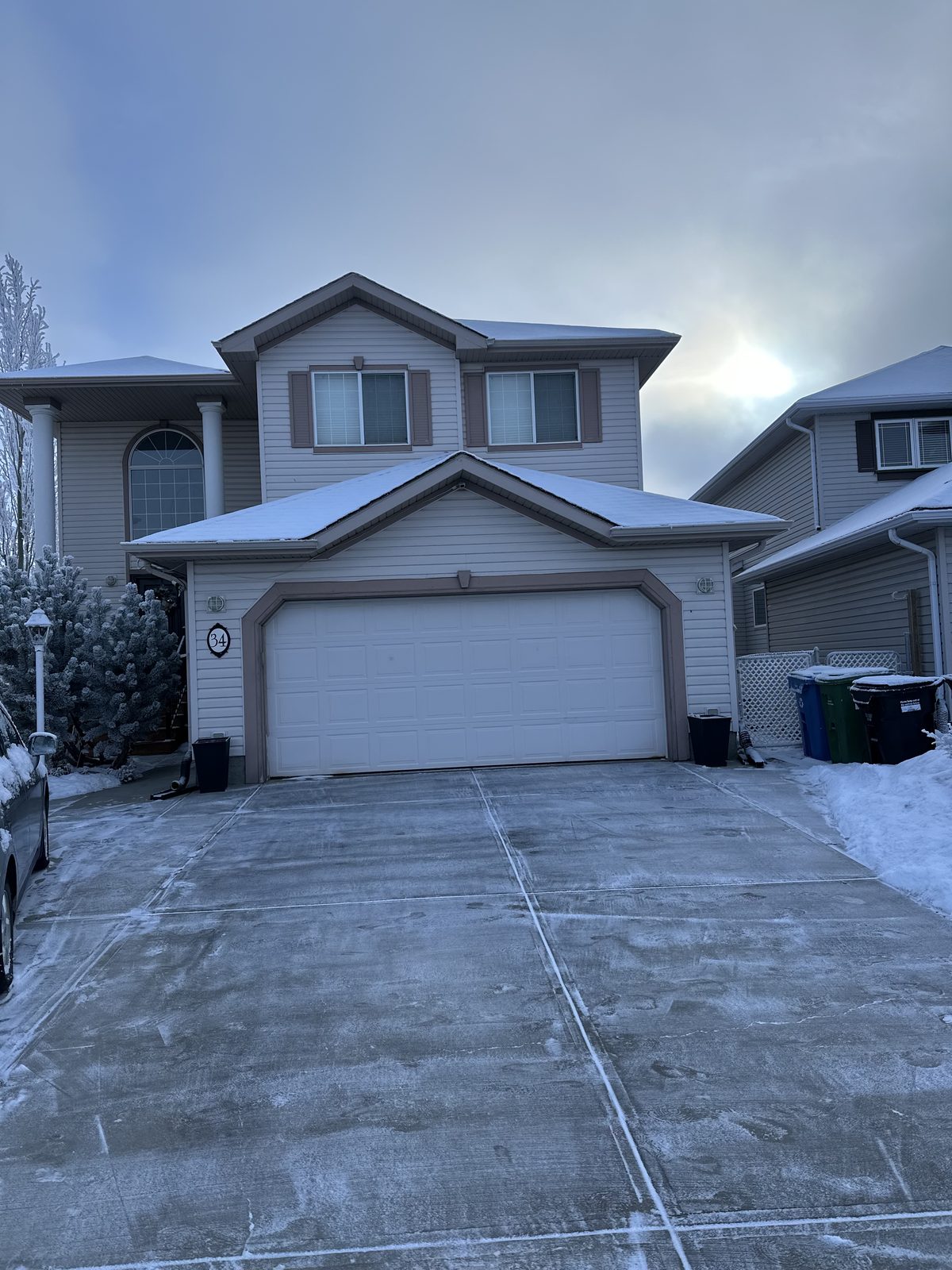 Residential Calgary driveway cleared to bare concrete after a snowfall